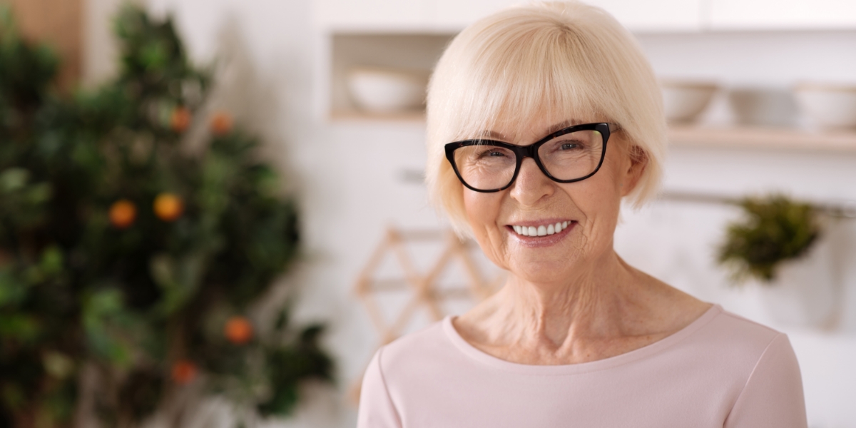 senior lady with glasses and dental implants